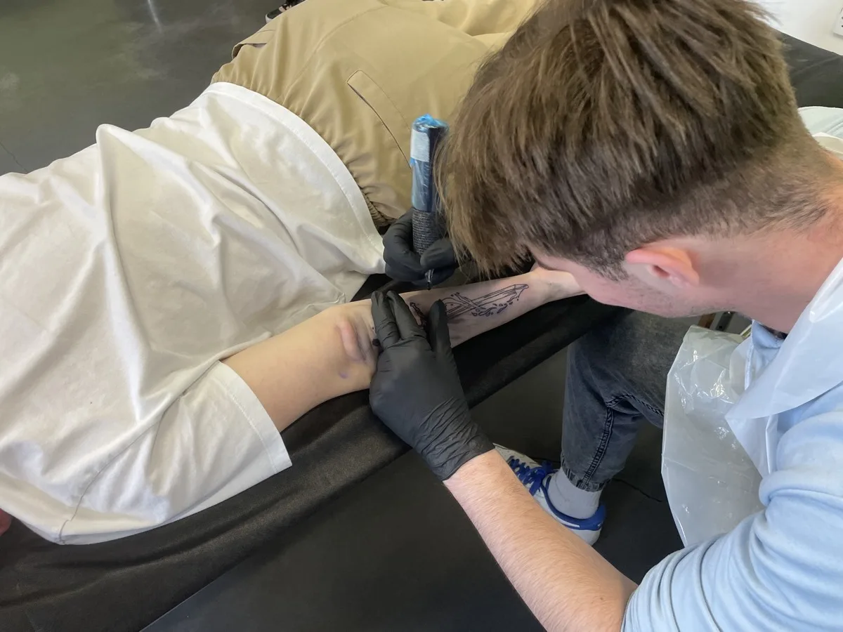 Fine line sword tattoo detail